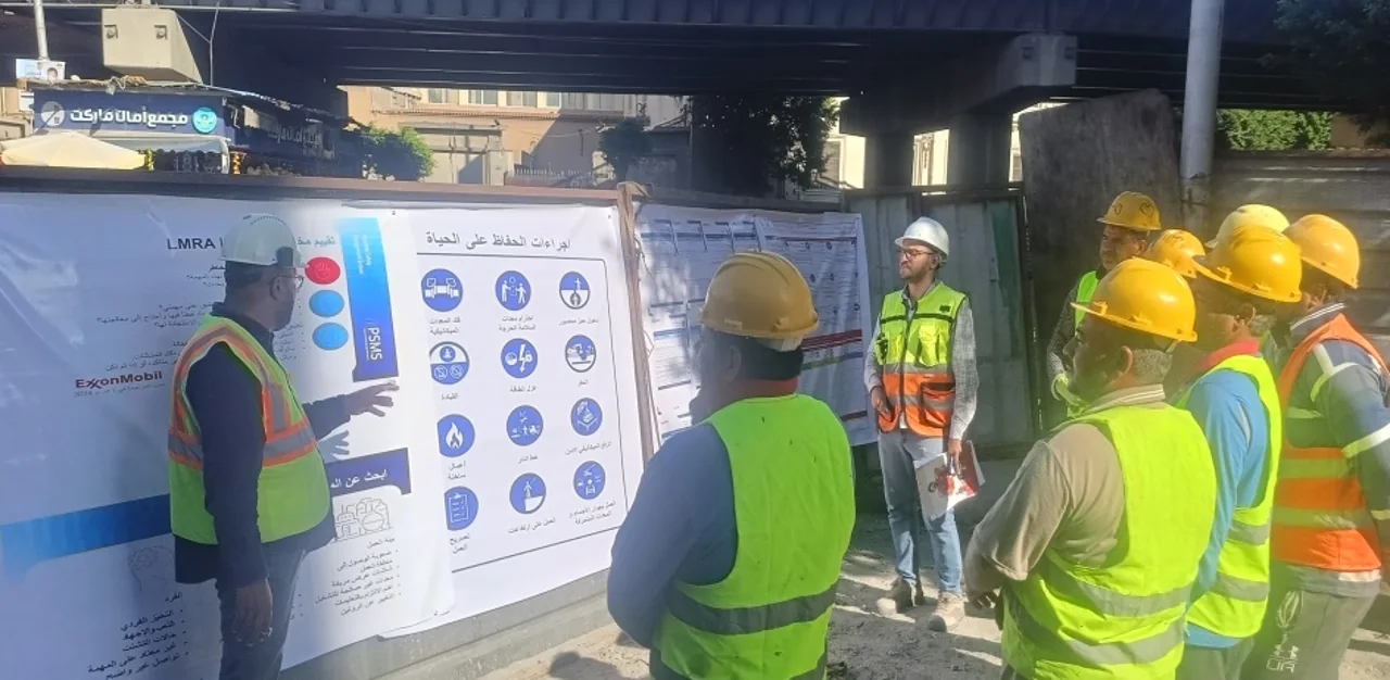 Dimass workers reviewing safety guidance